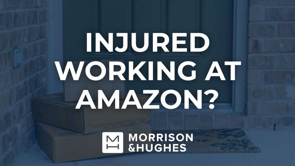 boxes in front of a door for amazon with text overlayed saying "injured working at amazon?"