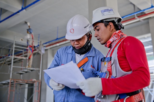 Union worker in safety gear at an industrial worksite