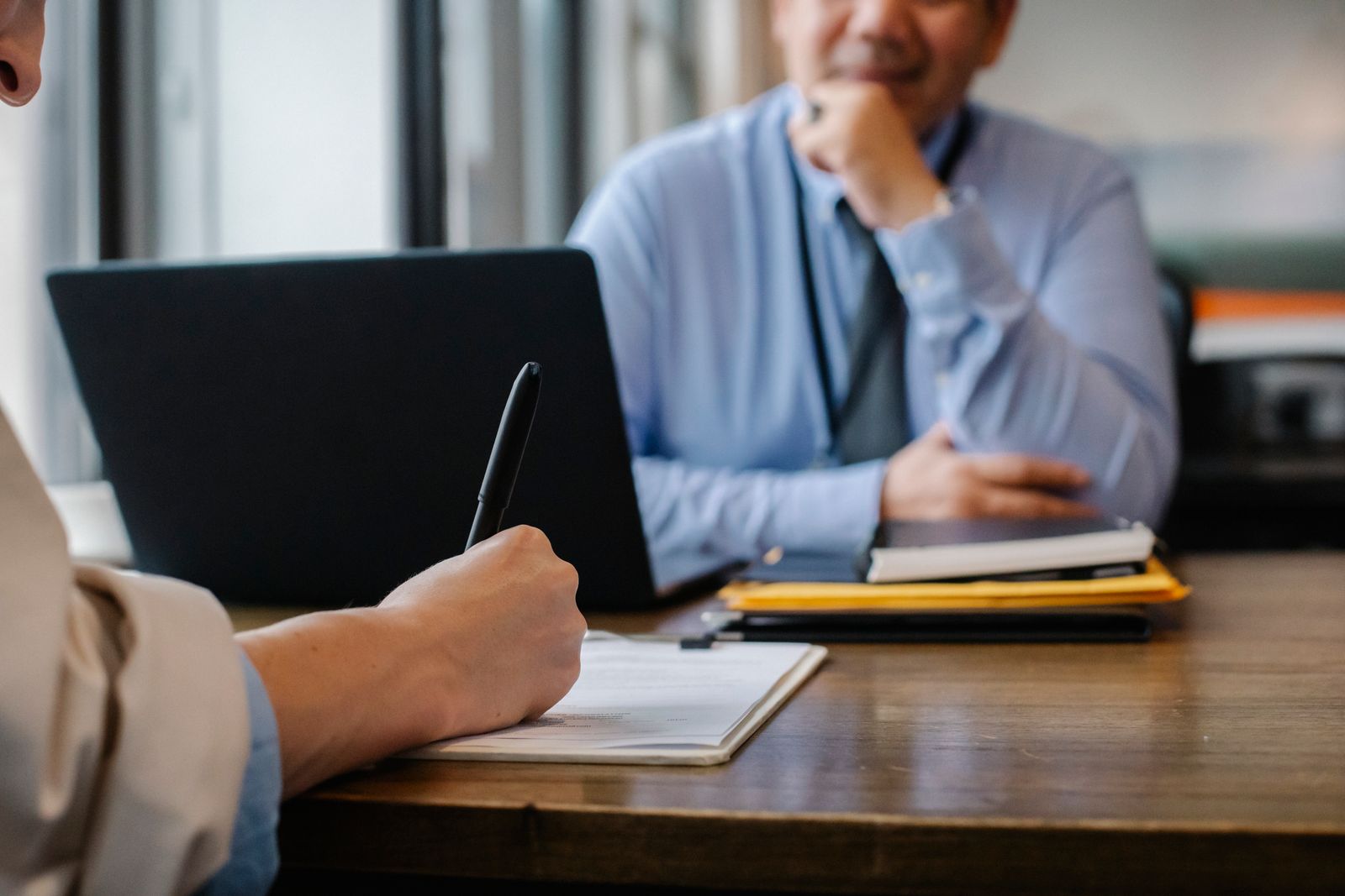 Defense attorney reviewing financial documents and contracts with a client