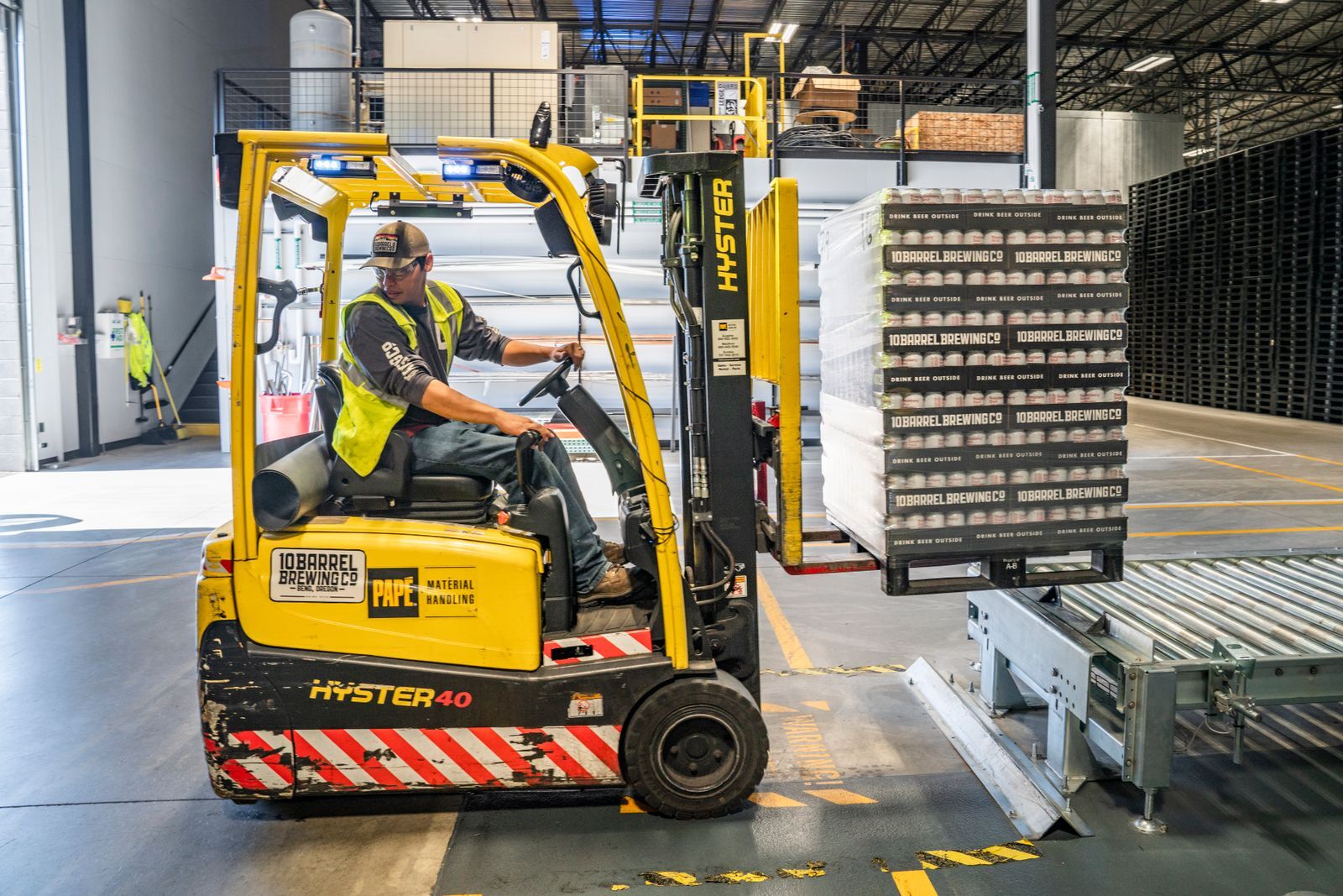 Worker on a Georgia factory and warehouse floor surrounded by industrial machinery