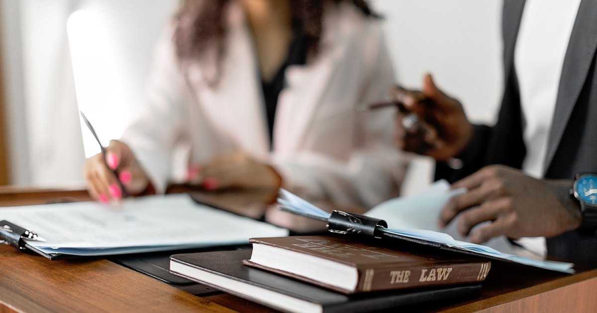 A client reviewing a car-accident injury claim and paperwork with a Georgia personal injury lawyer