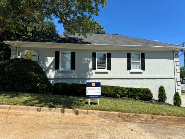 Side view of the Marietta office with the Morrison & Hughes injury attorneys sign