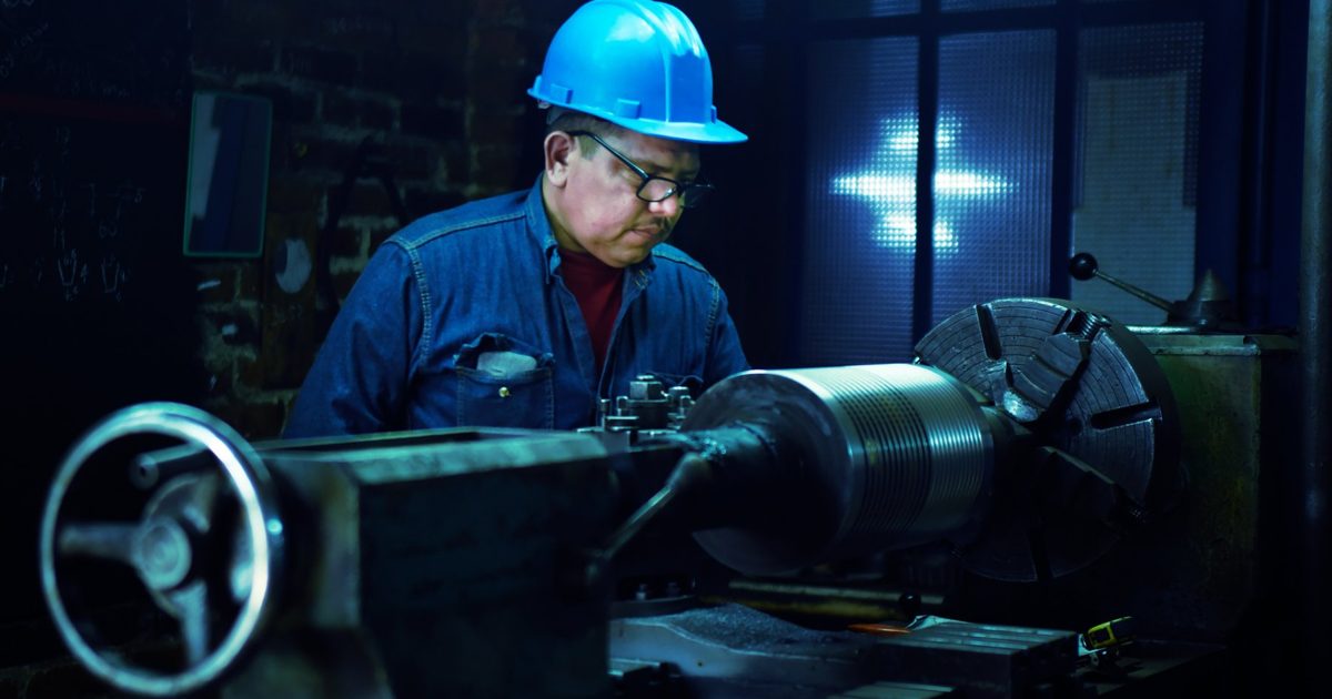 Stock photo of an industrial worker operating machinery, illustrating workers' comp and wrongful death claims after a contractor's death